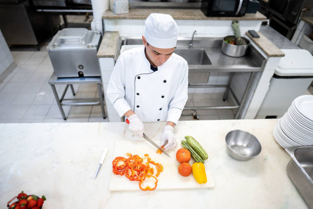 istock Head chef chopping vegetables in a commercial kitchen 2170828882