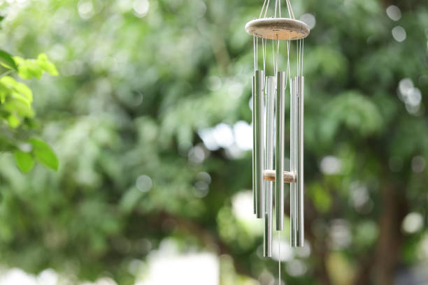 istock Wind chimes with green blurred background. Metal wind chimes with blurred background. 2170829185