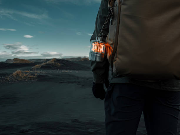 rear view asian female explorer with led light Standing at sand dune black sand beach stokksnes, Iceland