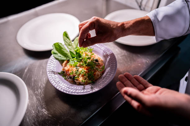 istock Chef decorating dish in a industrial kitchen 2170830066