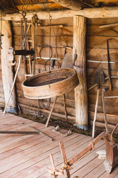 istock Antique farming tools in a rustic wooden barn 2170830100