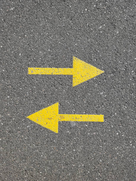 istock Two yellow arrows painted on the asphalt, top view. 2170830980