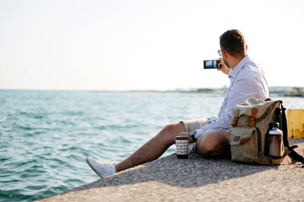 istock Man sitting by the sea 2170831307
