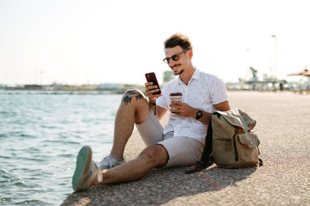 istock Man sitting by the sea 2170831341
