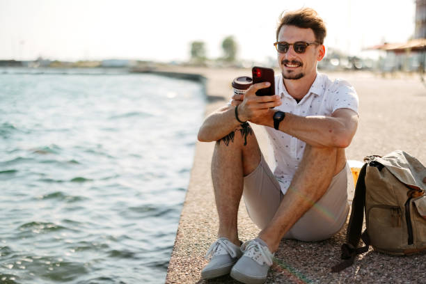 istock Man sitting by the sea 2170831356