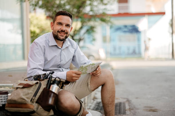 istock Male tourist is looking at a map 2170831464