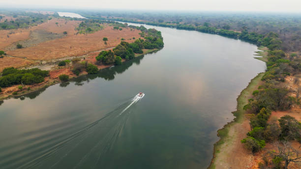 istock Small Boat Glides on Serene Kafue River 2170832334