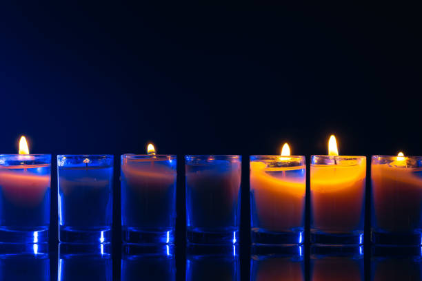 Burning candle on black background with backlight. . Memorial Day. High quality photo