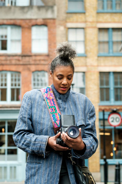 istock A mature model is taking pictures using an analog film camera. 2170834767