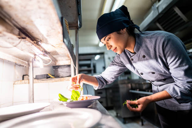 istock Chef finishing to prepare a dish in a commercial kitchen 2170834795