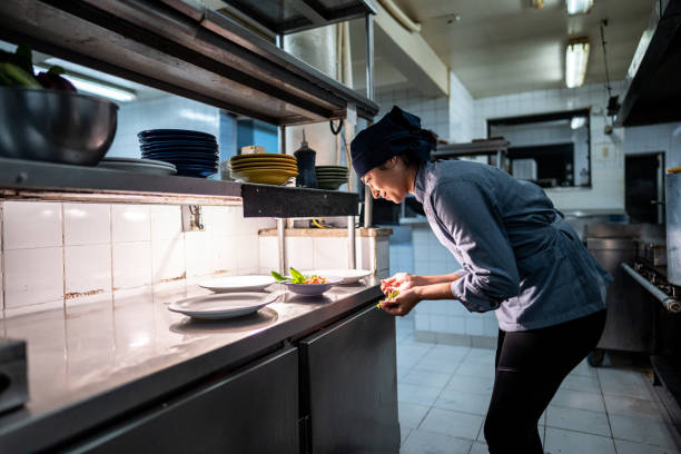 istock Chef finishing to prepare a dish in a commercial kitchen 2170834804