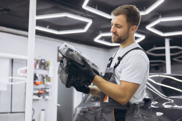 istock Mechanic in Modern Workshop Inspecting Car Headlight with Precision and Focus 2170835212