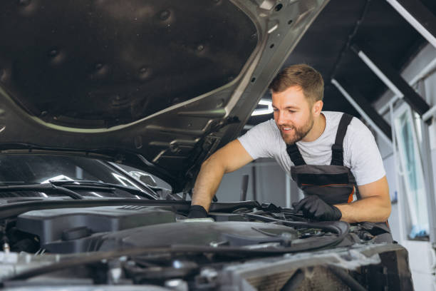 istock Professional Mechanic Smiling While Working on a Car Engine in an Auto Repair Shop 2170835271