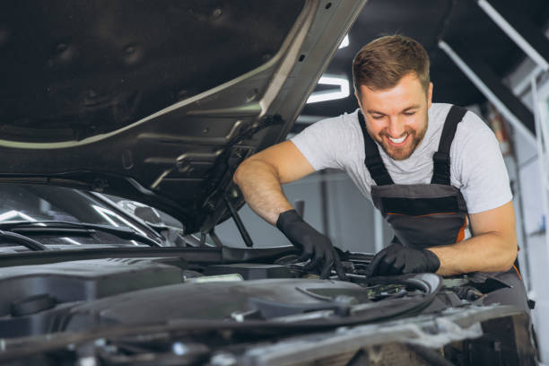 istock Professional Mechanic Smiling While Working on a Car Engine in an Auto Repair Shop 2170835328