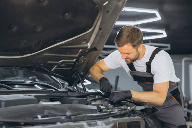istock Professional Mechanic Smiling While Working on a Car Engine in an Auto Repair Shop 2170835357