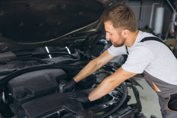 istock Professional Mechanic Smiling While Working on a Car Engine in an Auto Repair Shop 2170835786