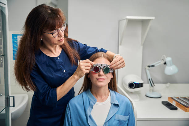 istock Doctor optometrist fitting trial frame on patient during eye exam 2170836696