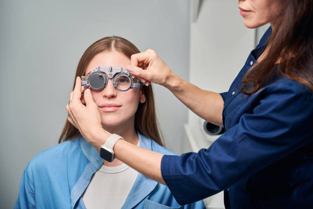 istock Female doctor optometrist adjusting trial frame on patients face 2170836759