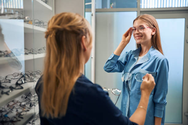 istock Customer trying on glasses with optician guidance 2170836766