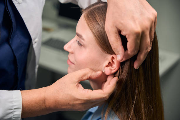 istock Doctor fitting hearing aid on patients ear 2170836777