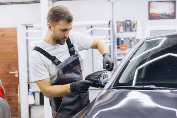 istock Professional Auto Mechanic Applying Protective Film to Car Mirror in Workshop 2170836824