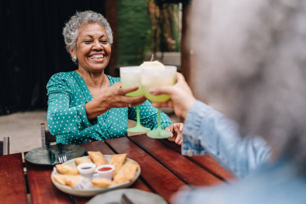 istock Senior woman toasting with friend on a restaurant 2170838607