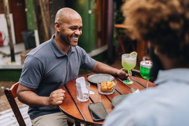 istock Mature man talking with friend at restaurant 2170838977