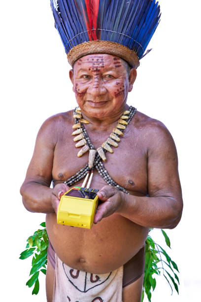 An elderly man from an Amazon tribe in Brazil charges a customer with his credit card using the credit car reader