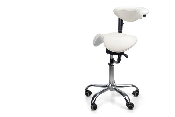 White saddle chair with backrest on casters with a split seat. Isolated on white background. Ergonomic lab chair.