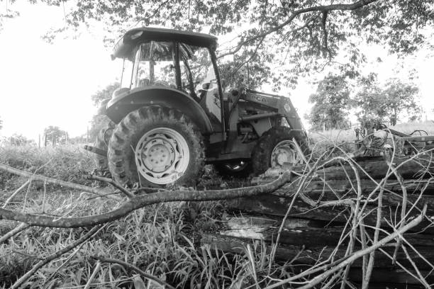 Tractor machine used on the farm in black and white, John Deere