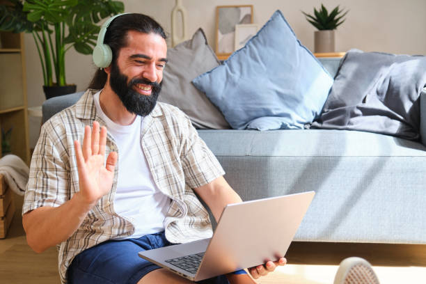 istock Happy freelancer waving during video call on laptop at home 2170845554