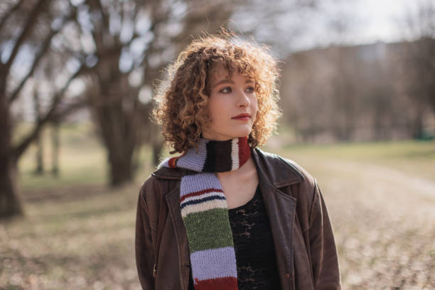 istock Redhead curly woman in park. 2170845764