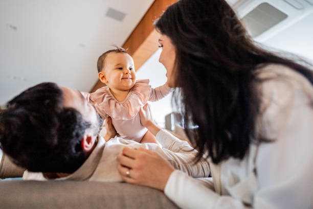 istock Parents talking and playing with their daughter at home 2170846415