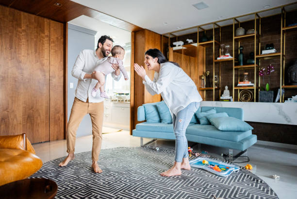 Parents talking and playing with their daughter at home