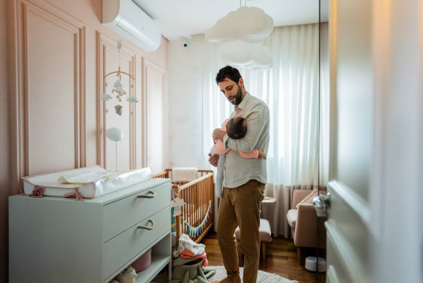 istock Father with daughter on his lap at home 2170847510