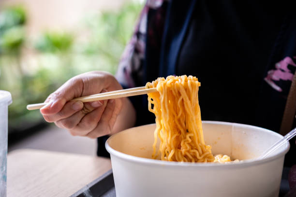 istock Women eating ramen using chopstick, chopstick holding some noodle 2170848178