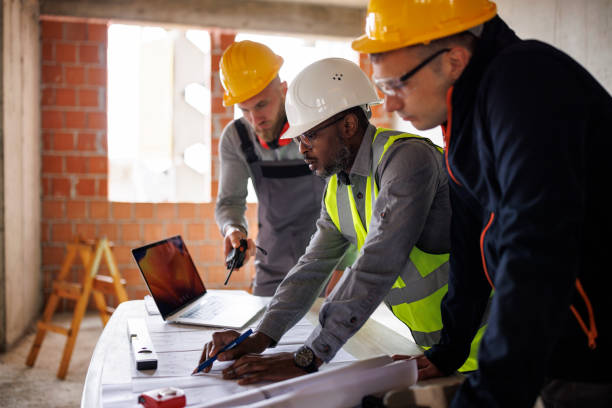 istock Engineer and construction workers discussing the blueprint project at the construction site 2170849642