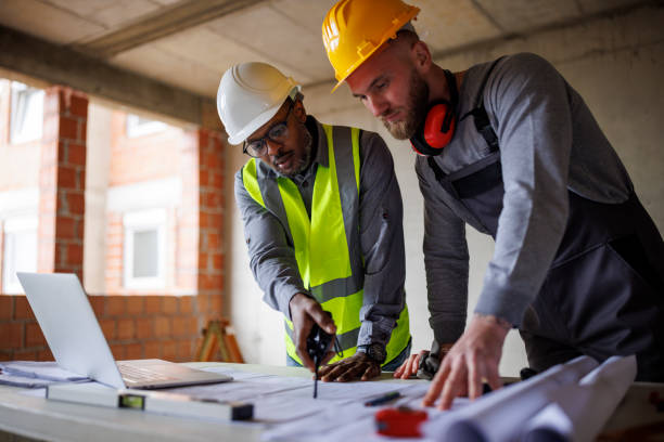 istock Engineer and construction worker discussing the blueprint project at the construction site 2170849649