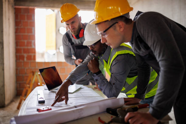 istock Engineer and construction workers discussing the blueprint project at the construction site 2170849651