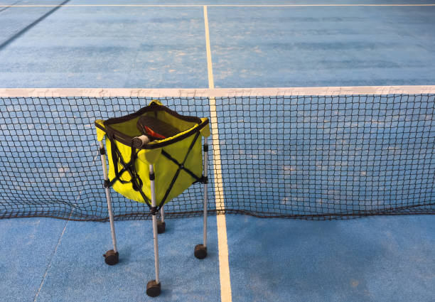 Padel balls on court in basket. High quality photo