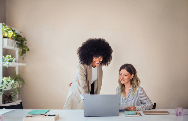 istock Colleagues Collaborating in Modern Office with Laptops and Plants 2170854783