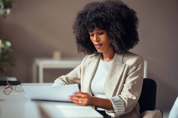 istock Focused Businesswoman Reviewing Documents at Office Desk 2170854796