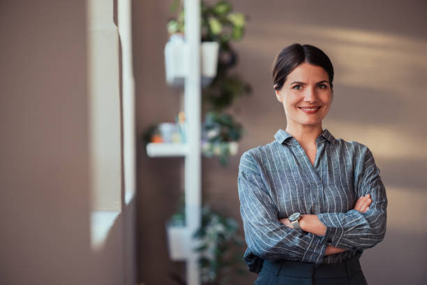 istock Confident Businesswoman Smiling in a Modern Office Setting 2170854856