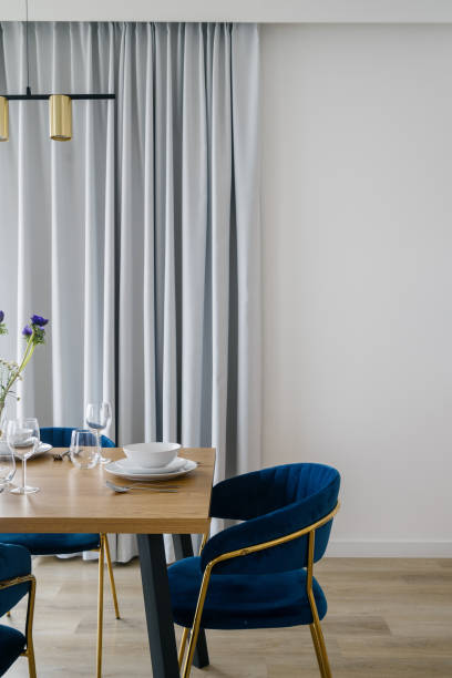 istock Dining room with blue velvet chairs and light curtains 2170859752