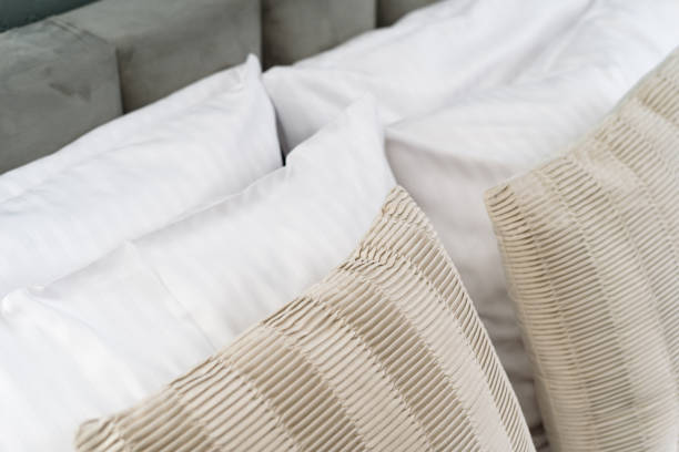 istock Decorative cushions and hypoallergenic pillow on comfort bed 2170859765