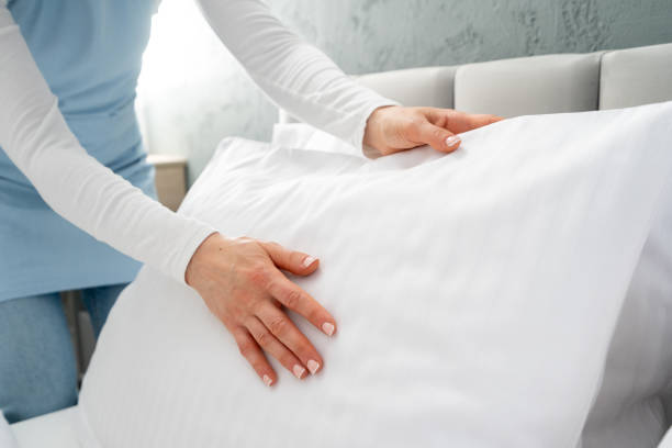 istock Housekeeper making a bed in hotel room 2170859780