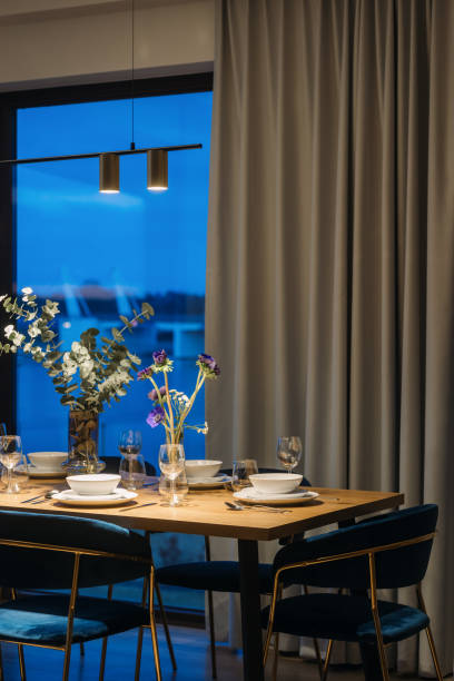 istock Dining room with table setting against city view on window at night 2170860952