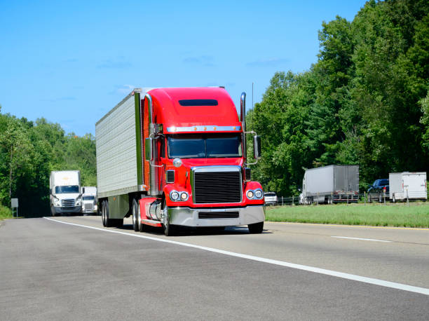 istock Red Eighteen-Wheeler Semi Truck On A Crowded Interstate Highway 2170861978