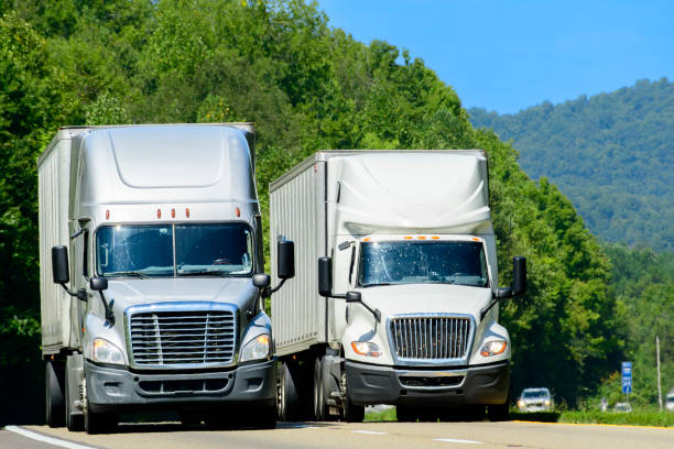 istock Two Eighteen Wheeler Semi Trucks Motor Down The Interstate Highway 2170862044