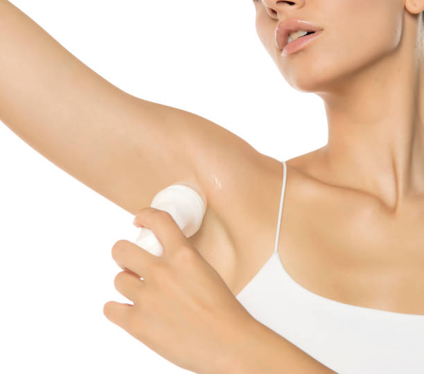 istock Woman applying deodorant roller under the arm on a white background 2170863936
